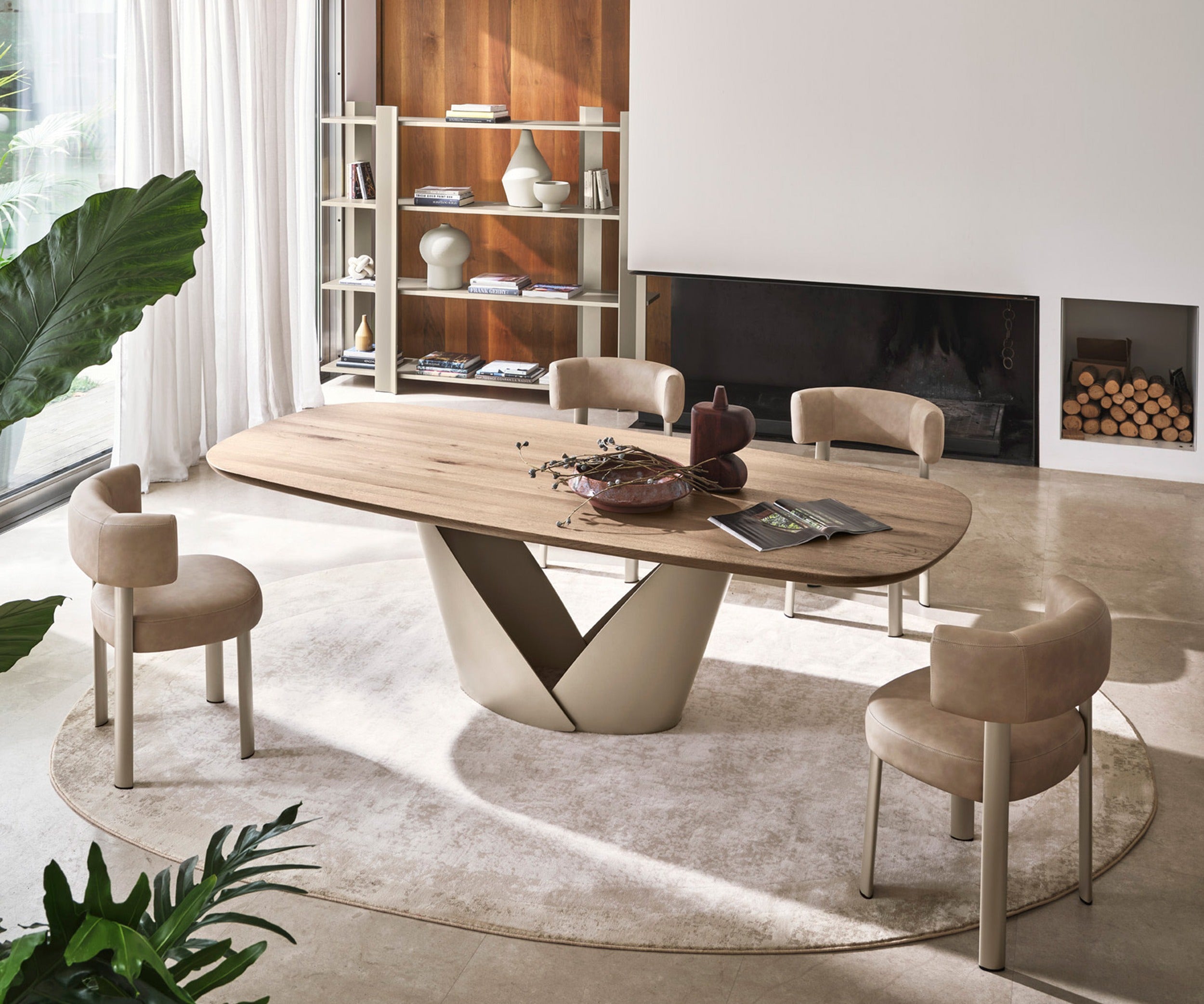 Bean rug by Calligaris under a dining table with four upholstered chairs