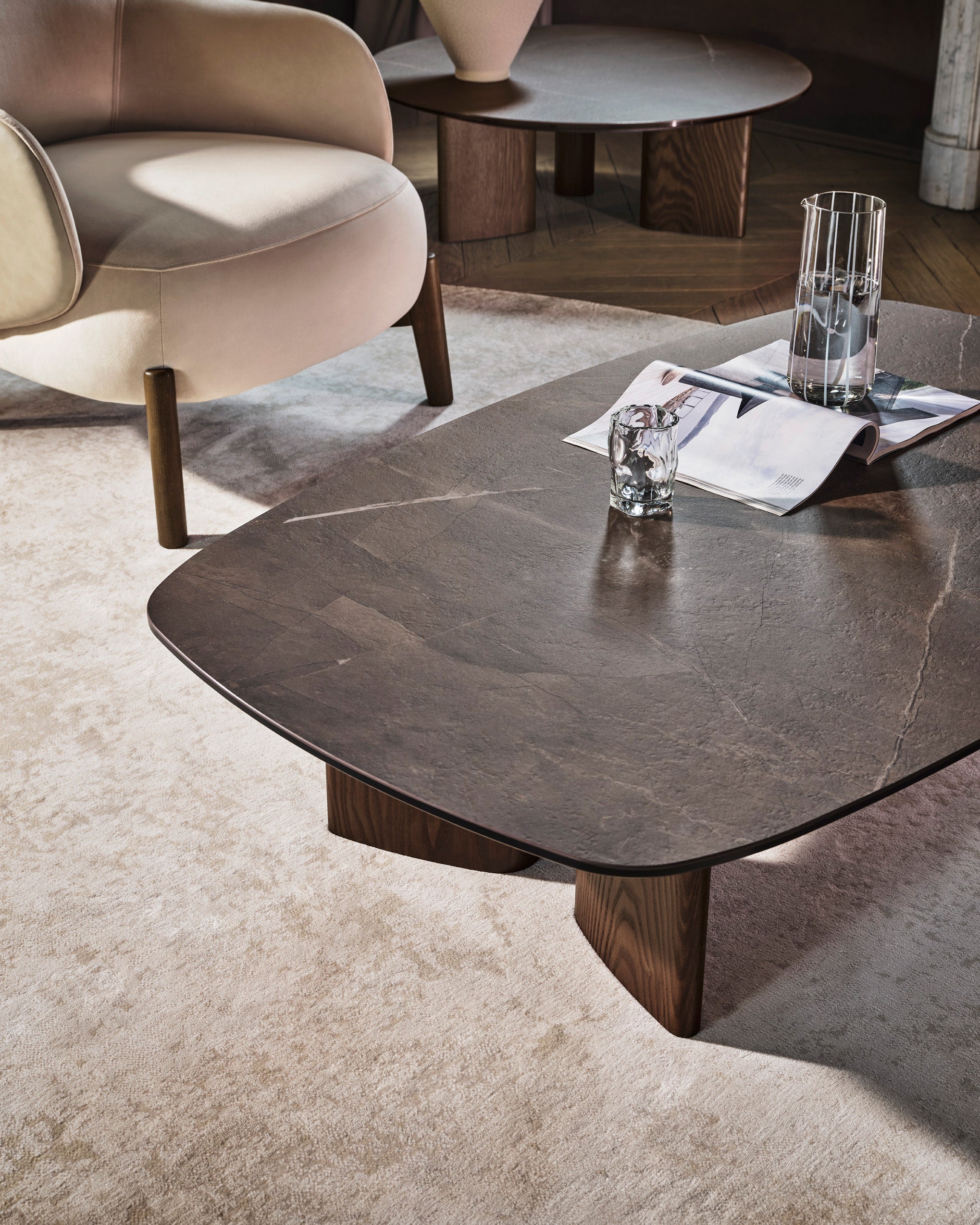Close-up of the Bean rug by Calligaris beneath a coffee table and armchair