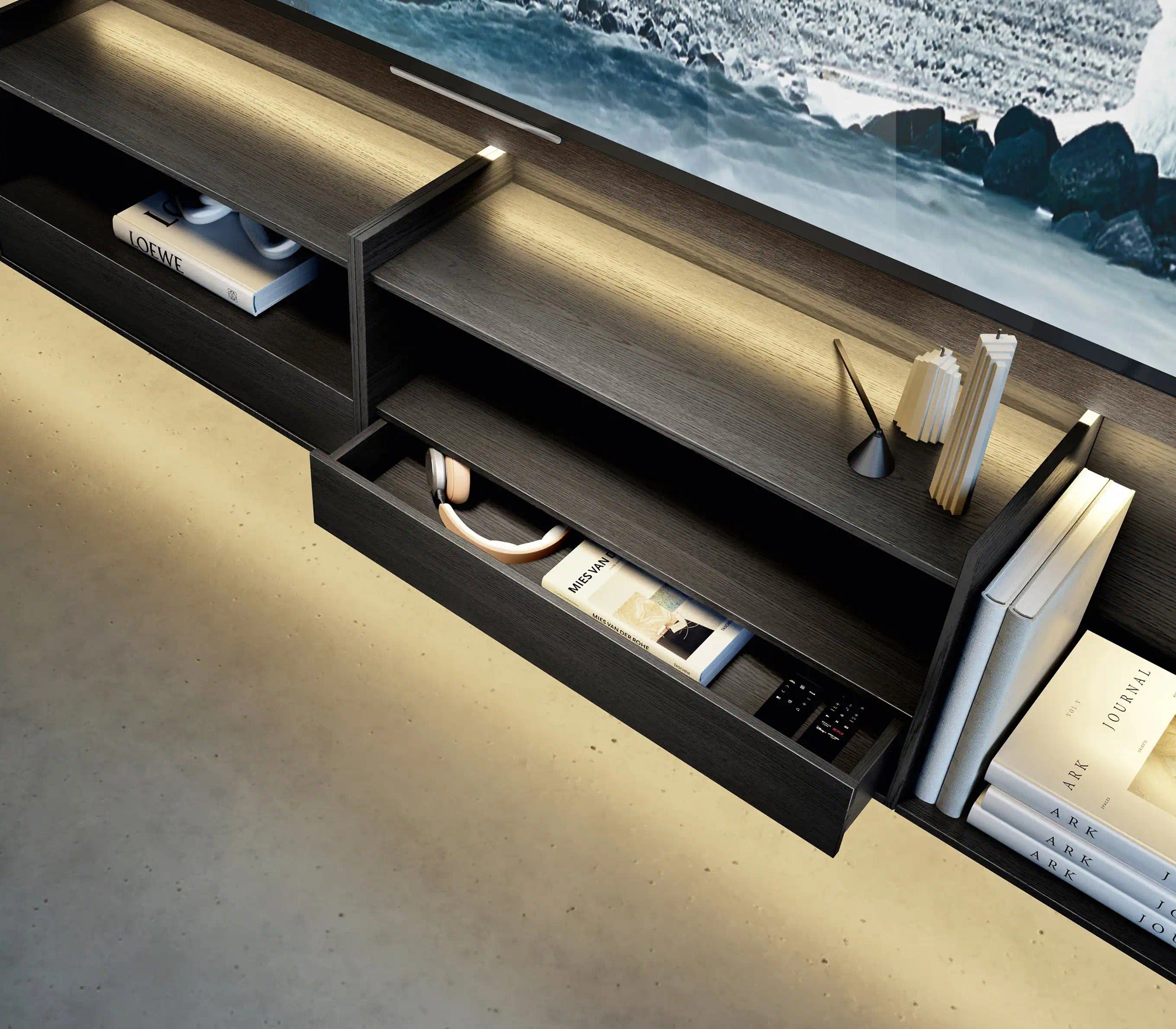Domino Composition 8257 detail: drawer pulled out beneath an open shelf in the dark oak base, with integrated lighting