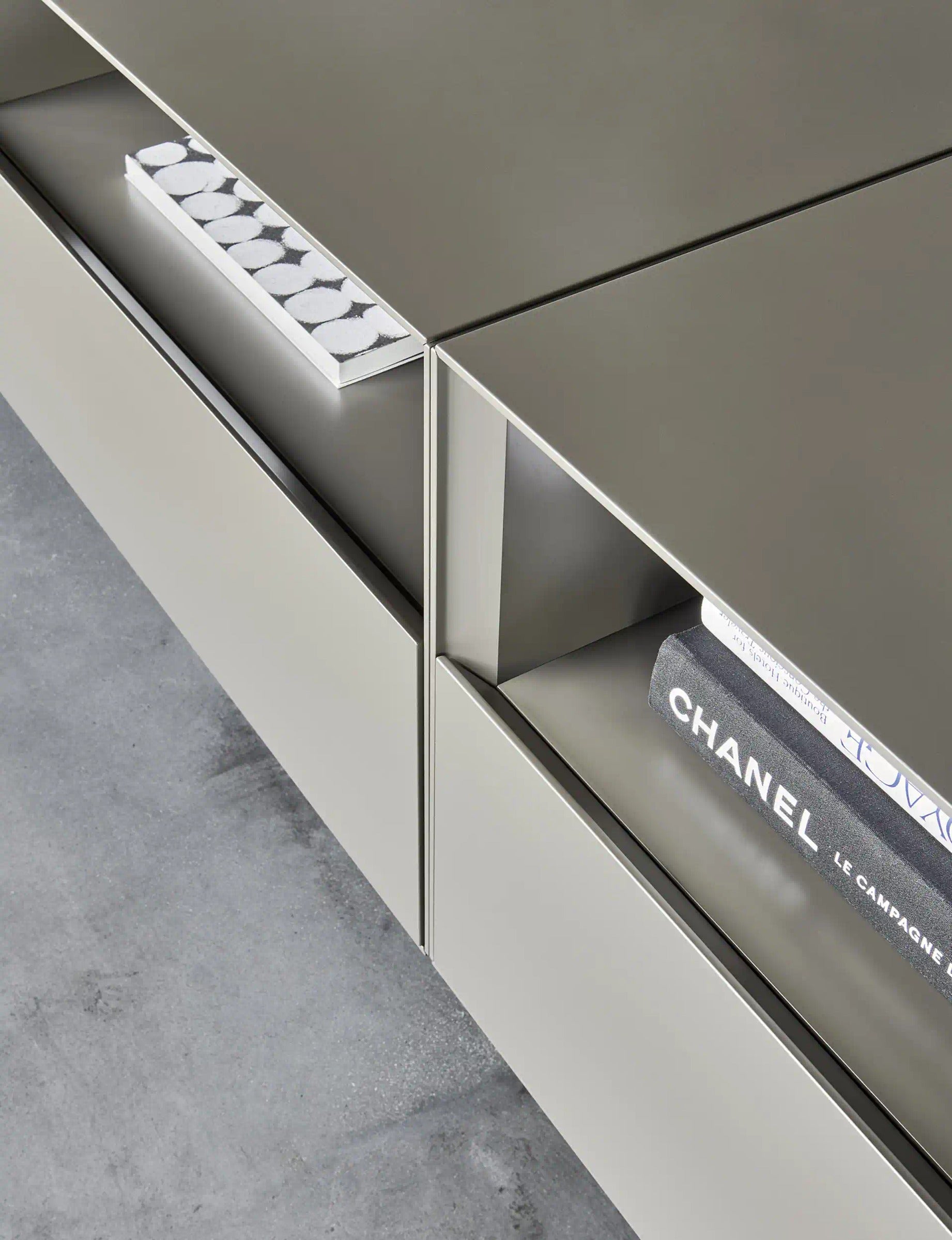 Domino Composition 9298 detail: Domino base drawer opening through the inclined upper edge of the front, beside an open compartment
