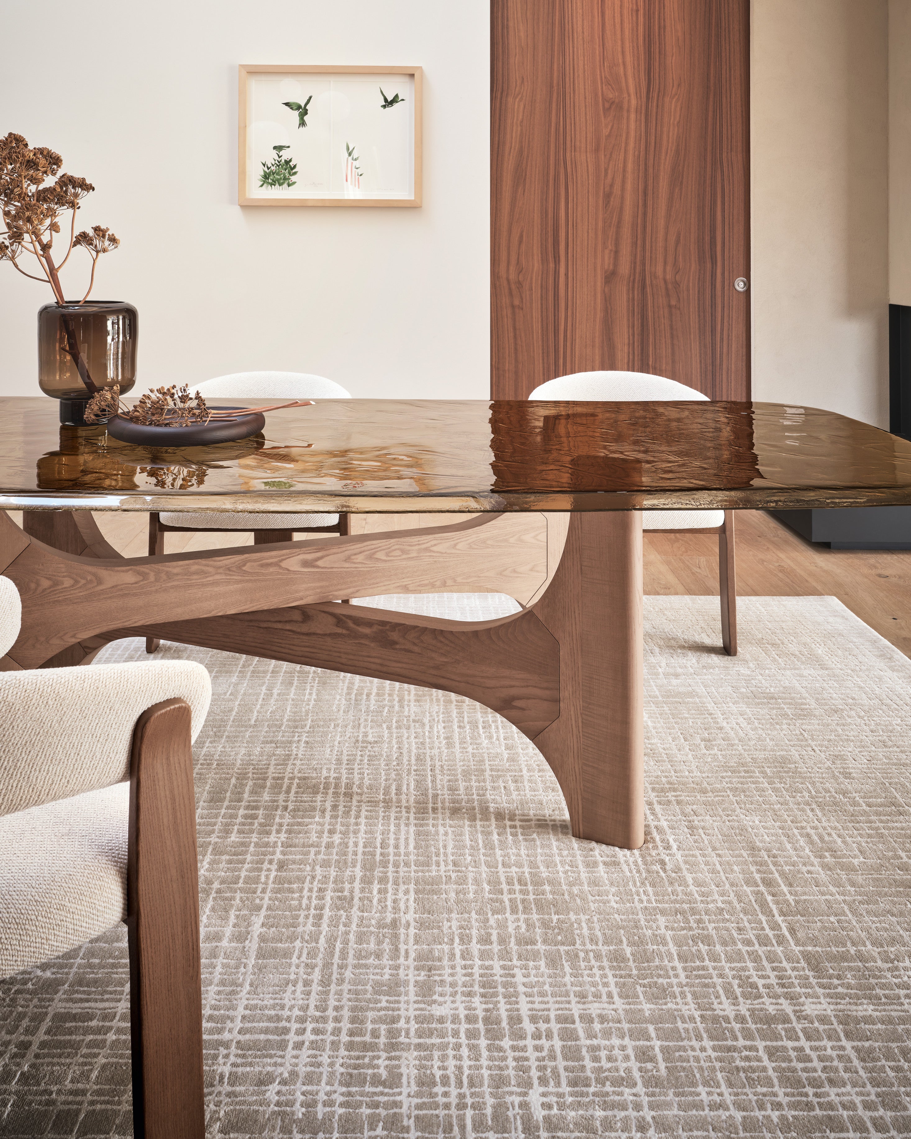 Close-up of the Nazca rug by Calligaris under a wood dining table base