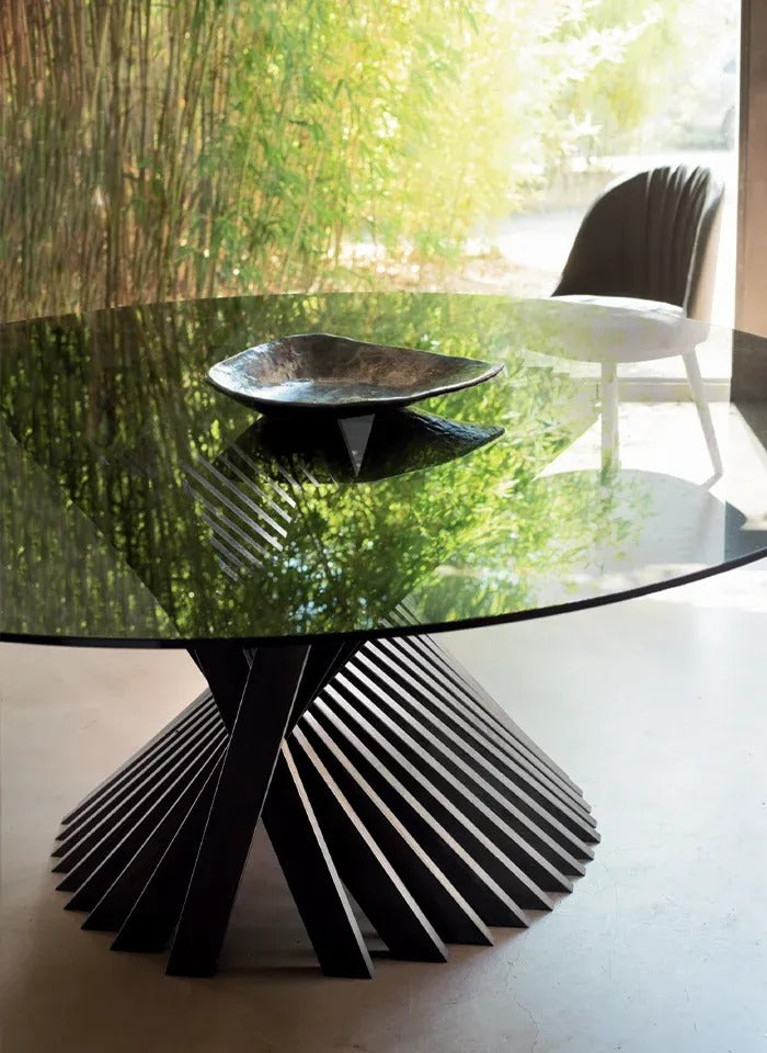 Close-up of the Nest dining table by Natisa with smoked glass top and dark twisted ash strip base