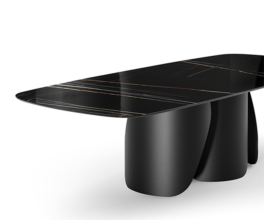 Onda Ceramic Top dining table by eforma, angled close-up of the black ceramic top and curved metal legs