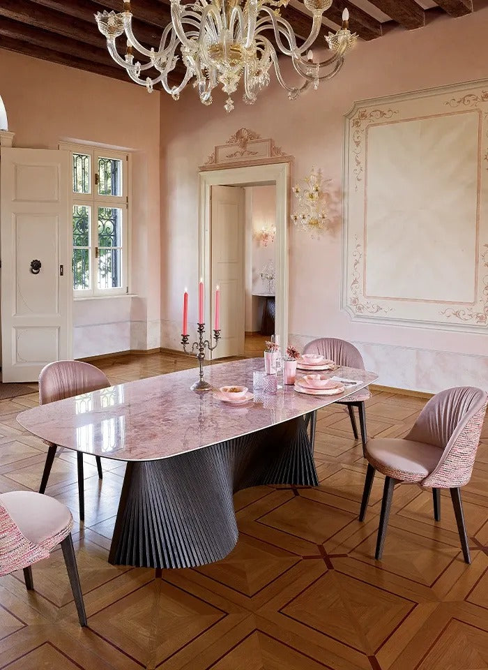 Orbit dining table with grey black base and pink marble-look top