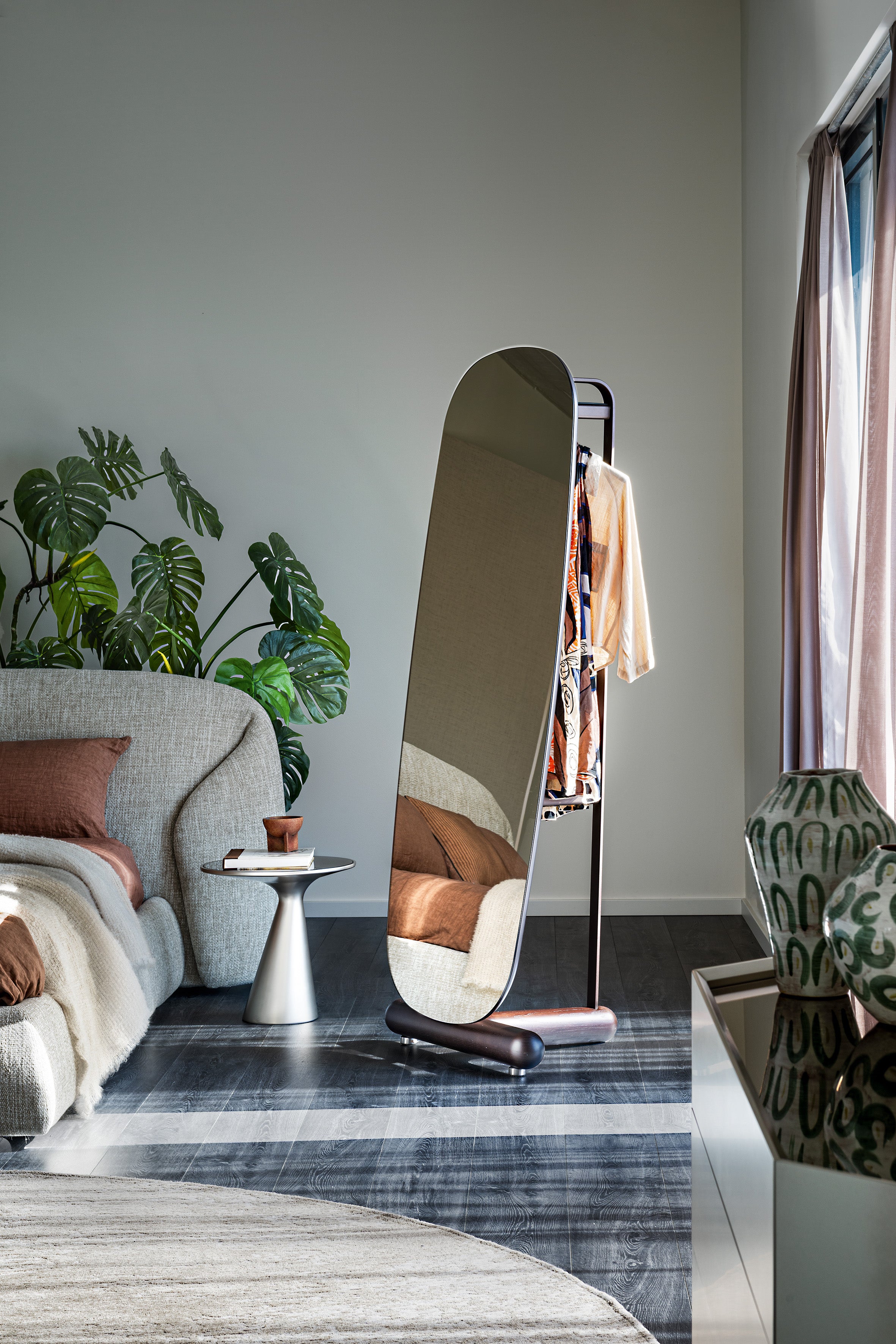 Pierre valet mirror in a sunlit bedroom, reflecting the bed